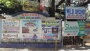 The signs at the entrance to Baloy Beach Road by National Highway